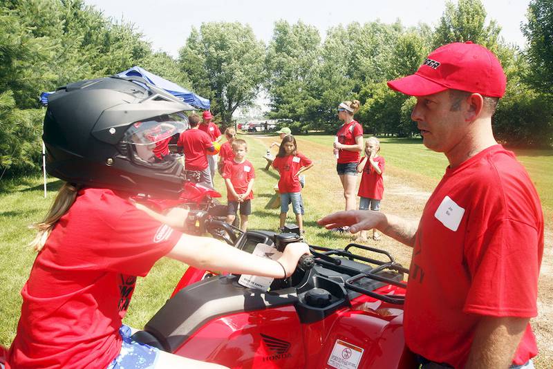 Joe Bail of Bob-Jo Cycle Company gives campers a lesson in all-terrain vehicle safety at the DeKalb County Farm Bureau's Farm Safety Camp at Jonamac Orchard June 27.