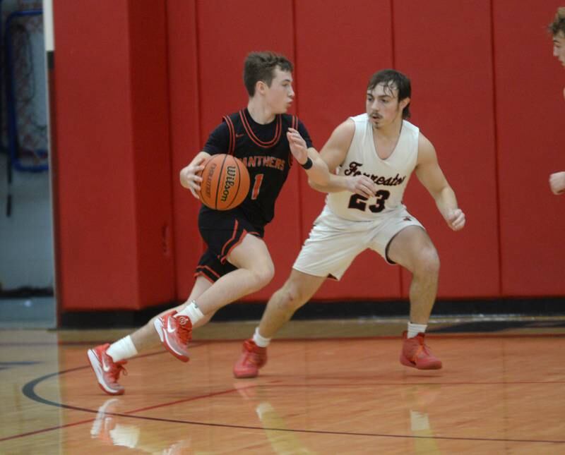 Erie-Prophetstown's Max Milem drives to the basket as Forreston's Kaleb Sanders defends during Saturday, Dec. 30, 2023 action at the Warkins Memorial Tournament at Erie High School.