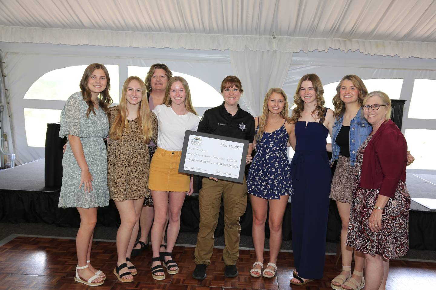 Deputy Theresa Damron accepts a donation from Gardner-South Wilmington High School students.