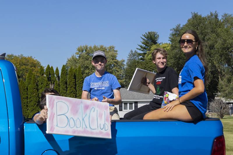 Newman book club members are seen Friday, Sept. 20, 2024, making their way through the homecoming parade.