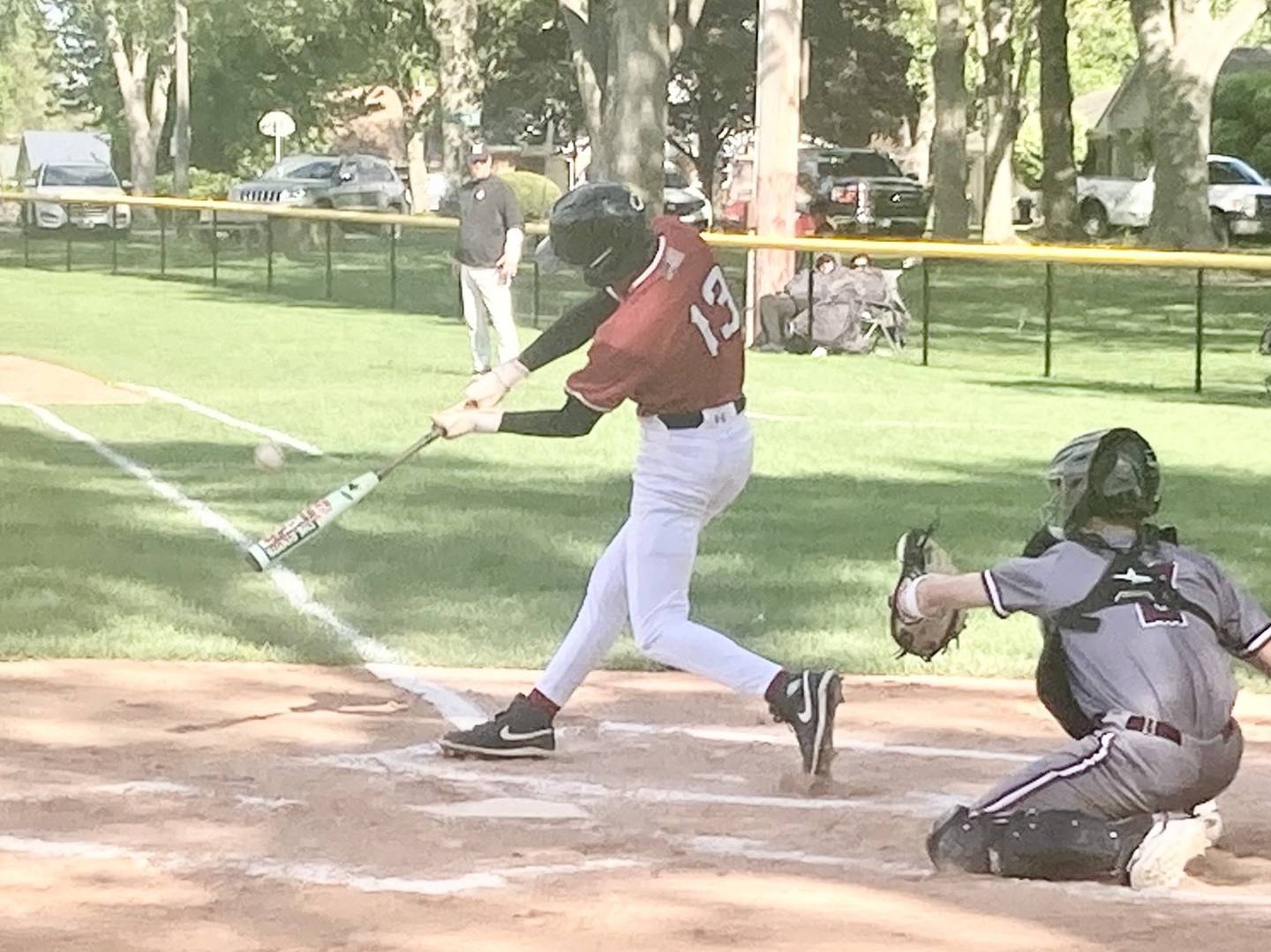 Hall's Noah Plym drives a sac fly to right field to tie the game at 1-1 in the bottom of the first inning Wednesday against IVC at Foley Field. The Red Devils won 8-7 on Jack Curran's walk-off single.
