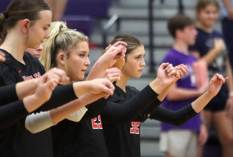 Huntley’s Abby Whitehouse, center, and Izzy Whitehouse, right, cheer before facing Hampshire in varsity girls volleyball at Hampshire High School in Hampshire on Tuesday, Sept. 23, 2025.