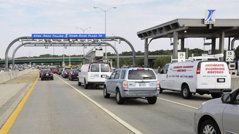 Drivers pass through the River Road Toll Plaza July 28 in Rosemont. On Thursday the Illinois Tollway Board of Directors approved a plan that will nearly double tolls to pay for a $12 billion capital plan.