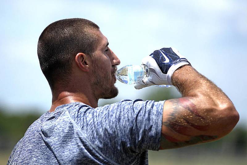 Houston Texans tight end C.J. Fiedorowicz hydrates during a work out with trainer Chris Leathers on Thursday, June 30 at Spring Grove's Thelen Park