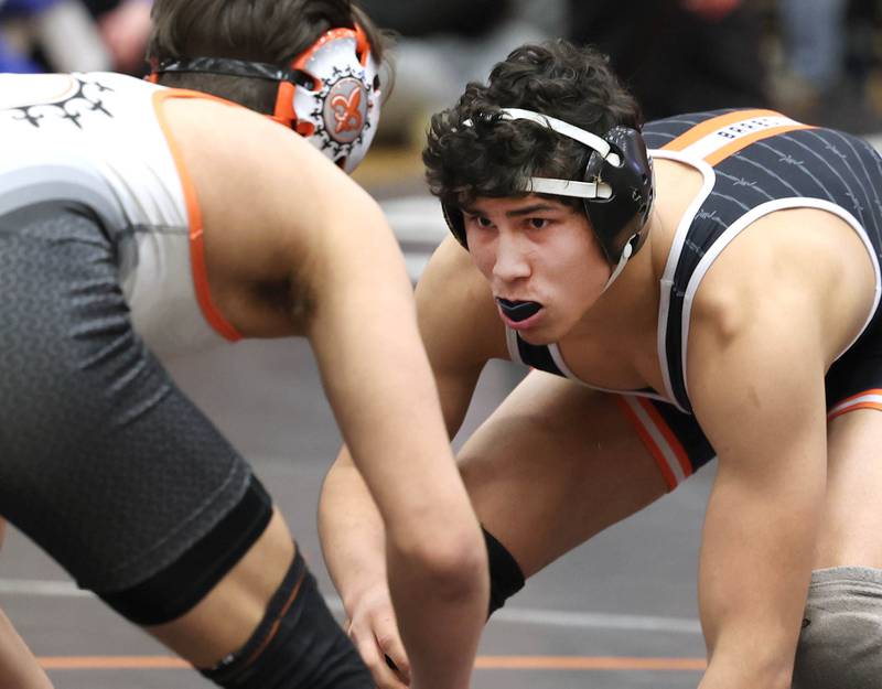 DeKalb’s Jacob Luce (right) and Anthony Gutierrez of St. Charles East meet in the 165 pound championship match Saturday, Feb. 3, 2024, in the Class 3A regional at DeKalb High School. Luce won the match with a 6-2 decision.