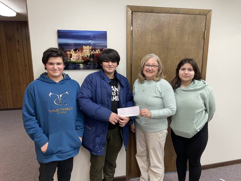 Luis Alvarez (left), Rafael Alvarez (middle left) and Alajandria Alvarez (right) of the St. Paul and Immanuel Lutheran churches youth ministry presented a $2,430 check to Vanessa Ankney (middle right) at the Dixon Public School's district office, Wednesday, Feb. 26, 2025. The youth ministry held two fundraisers in February geared towards eliminate the districts student lunch debt.