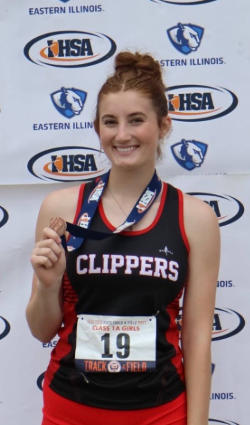 Ohio senior Jillian Anderson shows off her sixth-place medal in the high jump for the Amboy co-op.