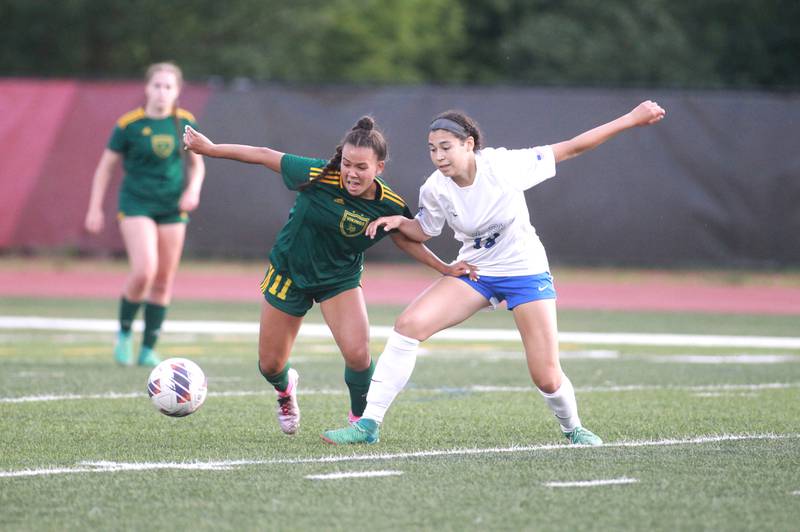Fremd’s Sophia Kennedy (left) and St. Charles North’s Juliana Park go after the ball during the Class 3A state semifinal game at North Central College in Naperville on Friday, May 31, 2024.