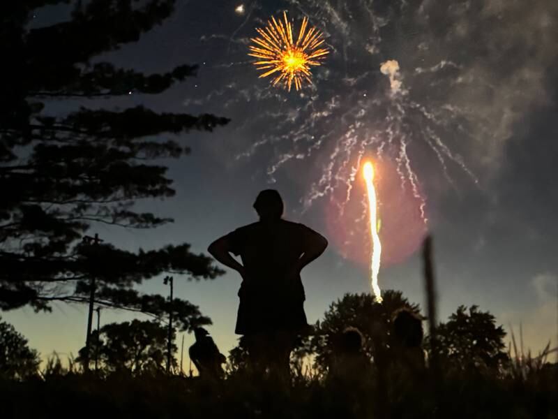 Woman watches fireworks on Saturday, June 29, 2024 at Lake Mendota.