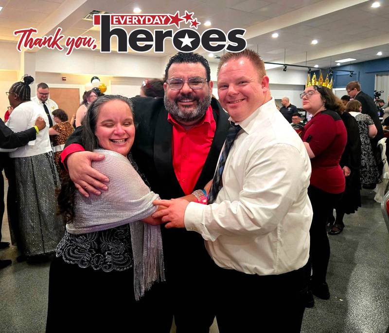 Valley Sheltered Workshop Executive Director Hugo Saltijeral is flanked by a client Mitch and his girlfriend, Katie, at the first-ever prom March 21.