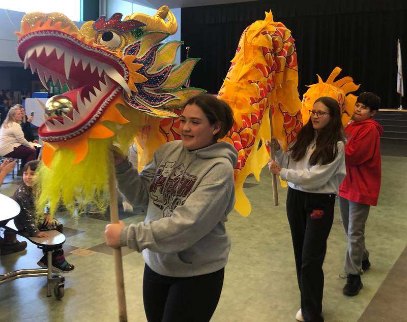 Students at JFK Elementary in Spring Valley hold a dragon as part of a parade for fellow students in celebration of Chinese New Year on Friday, Jan 27, 2022.