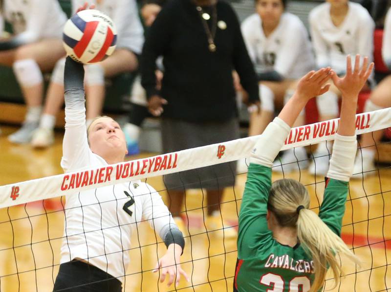Sycamore's Madie Patton spikes the ball past L-P's Aubrey Duttlinger on Tuesday, Oct. 15, 2024 in AJ Sellett Gymnasium at L-P High School.