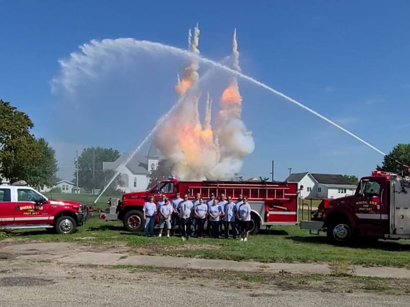 The Mineral-Gold Fire Department held an explosive ground breaking ceremony on Sept. 10 to announce the construction of its new fire station.
Back Row:  Trustee President/Treasurer Jennifer Blackert, Trustee Tim Bissonette, Jeffery Flint, Chief Jon Blackert, Dan Wilson, Allan Schultz, Jay Blackert
Front Row:  Trustee Merle Heston, Trustee Jason Ruff, Trustee Rosemary Goossens,  Carrie Wilson, Ward Blackert, Christy Bissonette
Missing:  Dave Jones and Alex Jones