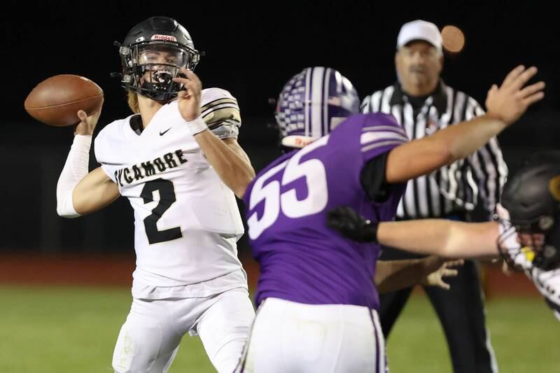 Sycamore's Elijah Meier throws the ball while under pressure from Rochelle's Kaiden Morris during their game Friday, Sept. 23, 2022, at Rochelle High School.