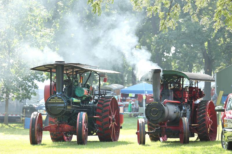 Two steam-powered tractors heat up during the Sycamore Steam Show Thursday, Aug. 10, 2023, at Taylor Marshall Farm in Sycamore. The show runs from 7 a.m. to 5 p.m. through Sunday.