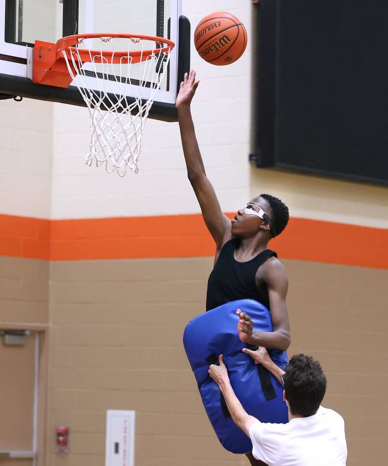 Gabe Crump, 15, from DeKalb, goes to the basket during a TRUTH Basketball Academy session Tuesday, June 25, 2024, at the school.