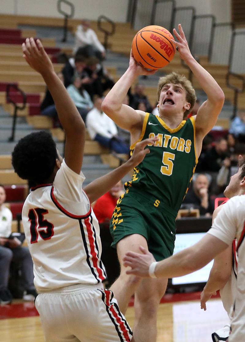 Crystal Lake South's Carson Trivellini drives to the basket against Huntley's Isaac Muze during a Fox Valley Conference boys basketball game on Wednesday, Dec. 10, 2025, at Huntley High School.