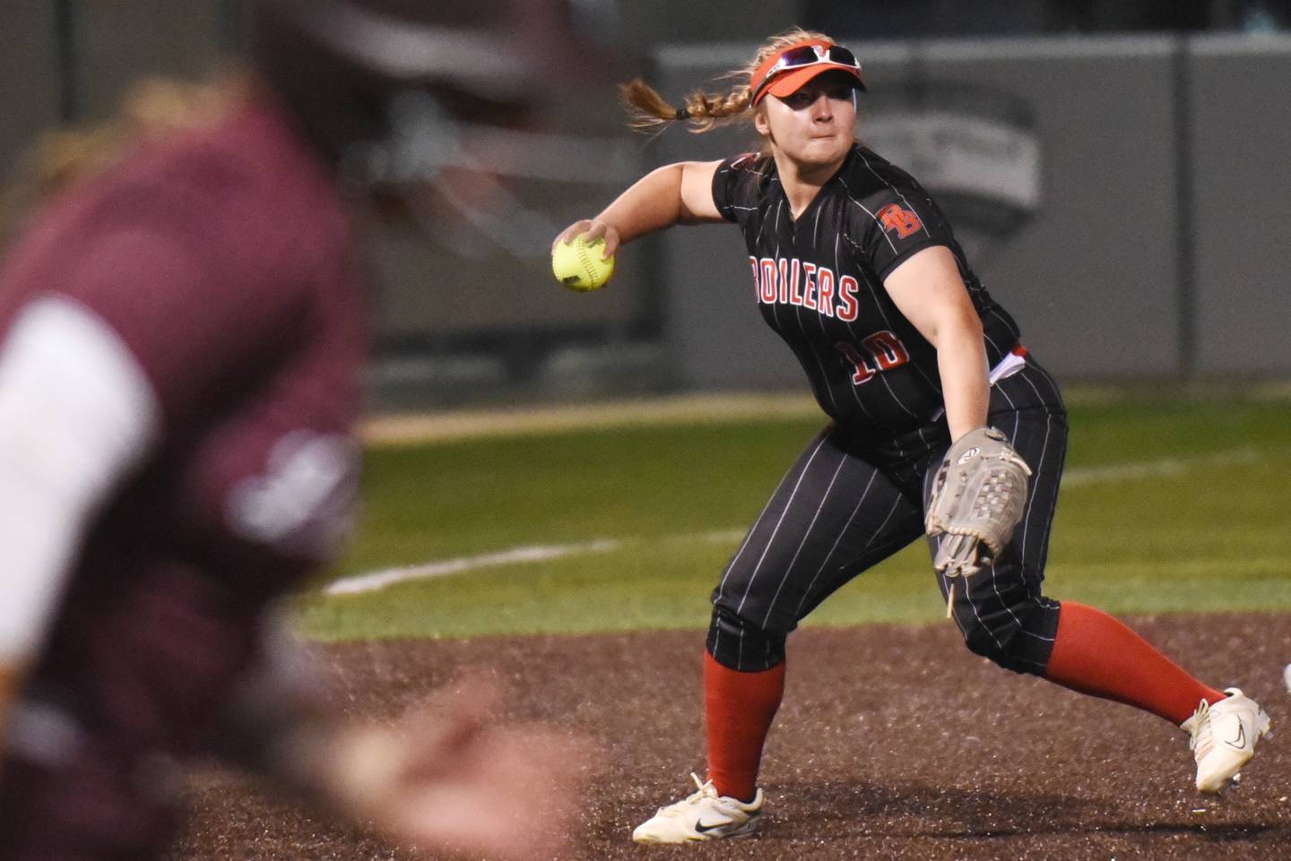 Bradley-Bourbonnais' Rhaina Boggess, right, attempts to throw Lockport's Sydney Amschler out at first base during the Class 4A Illinois Wesleyan Supersectional Monday, June 9, 2025.