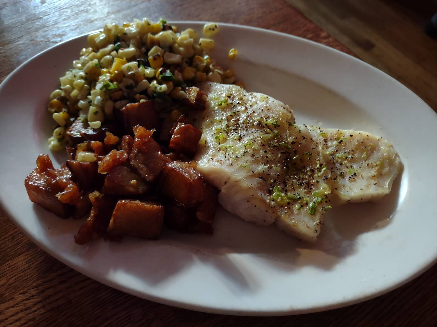 The broiled citrus and herb trigger fish at Canal Port in Utica is served with rosemary garlic red potatoes and southwest corn.