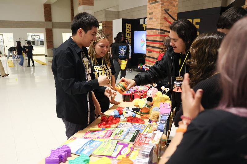 A student gets a prize at the annual Special Population Dance hosted by Joliet West high school on Friday, March 22, 2024.