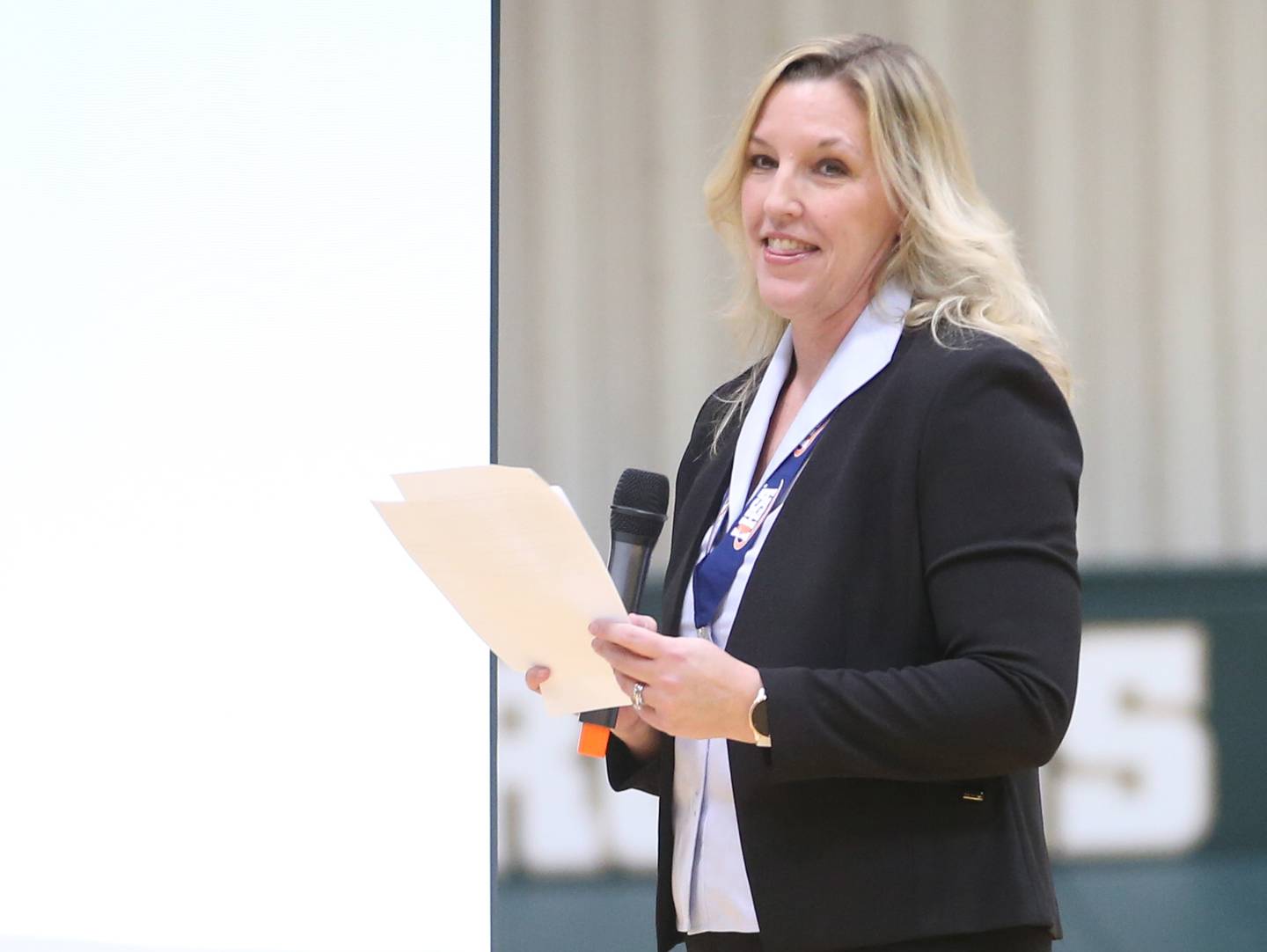 St. Bede girls basketball head coach Stephanie Mickley smiles while giving a speech during a celebration ceremony on Tuesday, March 5, 2024 in Abbot Vincent Gymnasium.