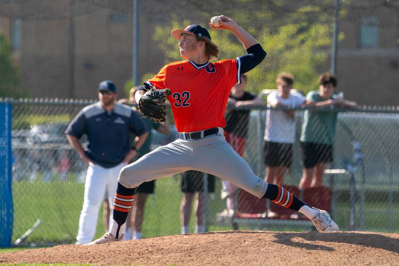 Oswego’s Noah Mottet (32) delivers a pitch against Oswego East during a baseball game at Oswego East High School on Wednesday, May 10, 2023.