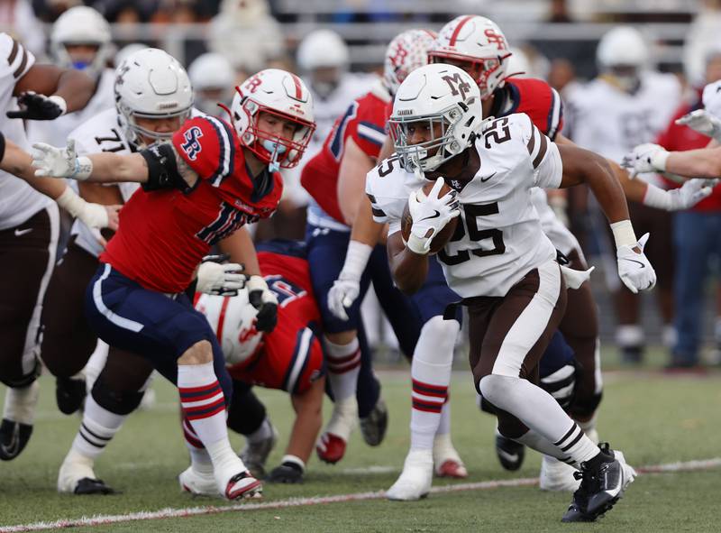 Mt. Carmel's Madden Wilson (25) runs the ball during the class 7A semi-final playoff game between Mt. Carmel and St. Rita high schools on Saturday, Nov. 23, 2024 in Chicago.