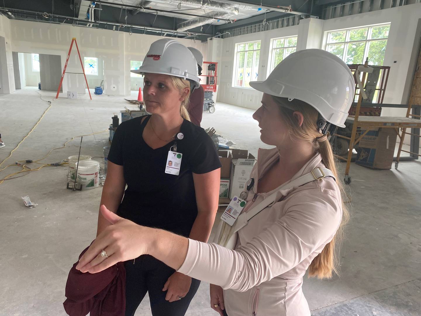 Erin Hill and Becca Evola from Morris Hospital survey construction progress in the rehab gym at the new Morris Hospital YMCA earlier this summer. Morris Hospital will be providing a range of services at the new Y when it opens in December.