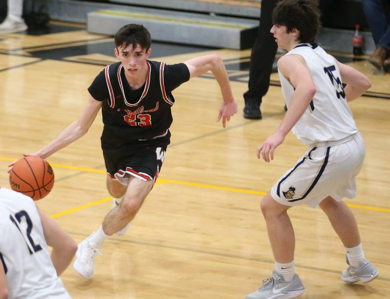 Woodland's Nick Plesko dribbles around Marquette's Alec Novotney during the Tri-County Conference Tournament on Thursday, Jan. 25, 2024 at Putnam County High School.
