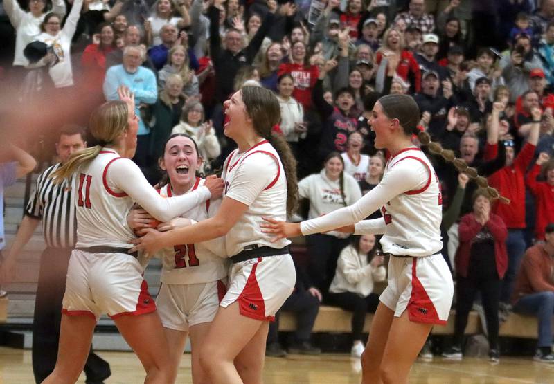 Huntley’s Red Raiders celebrate as the clock expires on a win over Lake Zurich in IHSA Class 4A Sectional girls basketball action on Tuesday, Feb. 25, 2025, at Huntley High School in Huntley.
