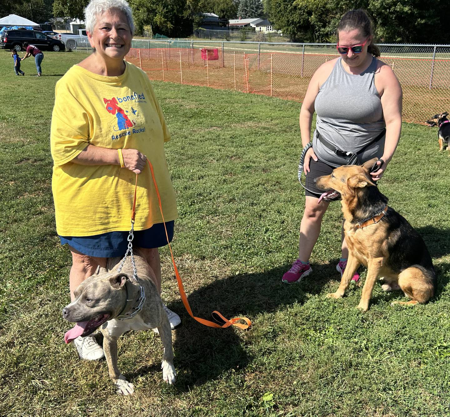 Melodee Hoffman (left) and Sandra Moore pose with Tully and Hawkeye at the Bonafied Rescue Rally in Oregon on Saturday, Sept. 27, 2025. Both dogs are available to be adopted through Bonafied.