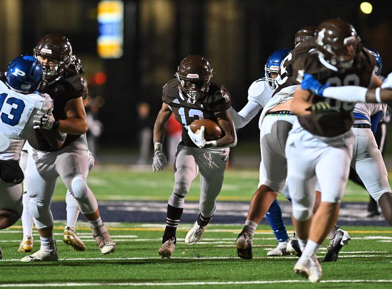 Joliet Catholic's HJ Grigsby (13) runs the ball during IHSA Class 4A first round playoff on Friday, Oct. 28, 2022, at Joliet. (Dean Reid for Shaw Media)