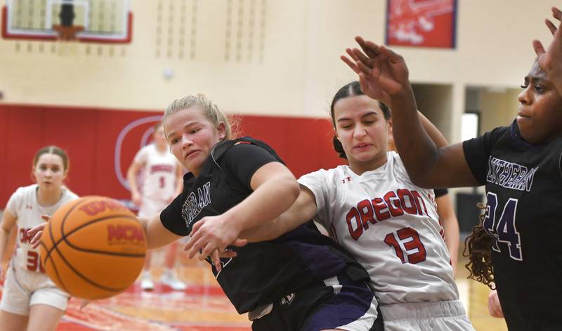 Oregon's Sarah Eckardt (13) and Rockford Lutheran's Laney Carlson (11) and Danielle Johnson (24) battle for a loose ball on Saturday, Jan. 24, 2026 at the Blackhawk Center in Oregon.