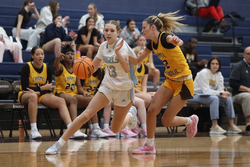 Joliet Catholic’s Abigail Dulinsky works against Carmel’s Josie Hartman on Wednesday, Jan 15, 2025 in Joliet.