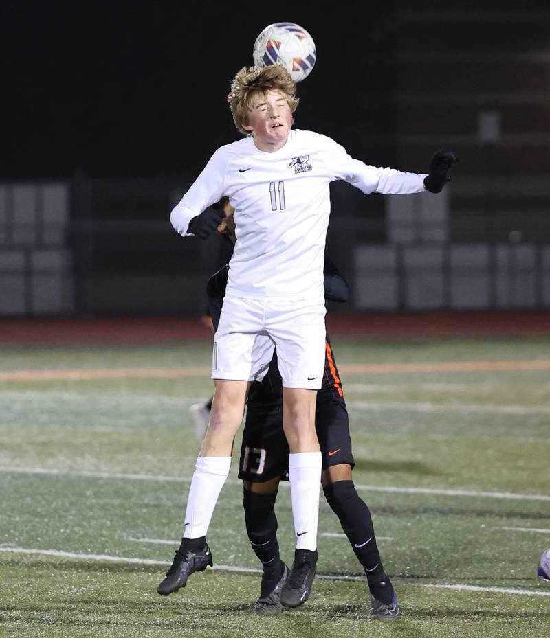 Kaneland's Matthew Mitchinson heads the ball in front of DeKalb’s Henry Garcia Alvarez during their game Thursday, Oct. 12, 2023, at DeKalb High School.