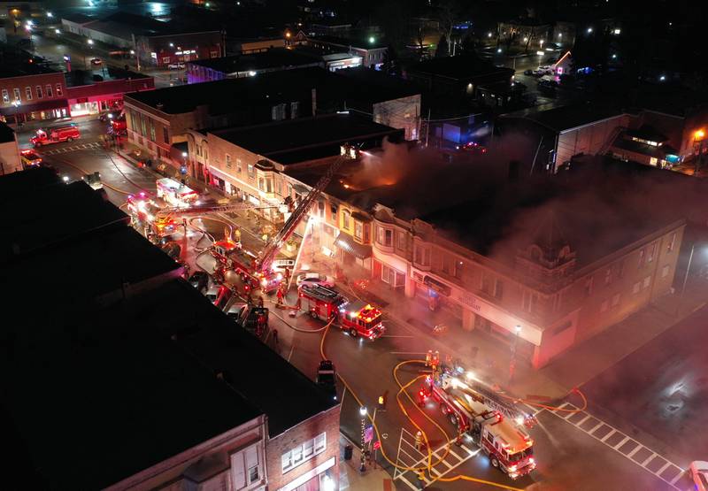 An aerial view of firefighters battling an apartment fire in the second story at 708 Illinois Avenue on Friday, Dec. 30, 2022 downtown Mendota.