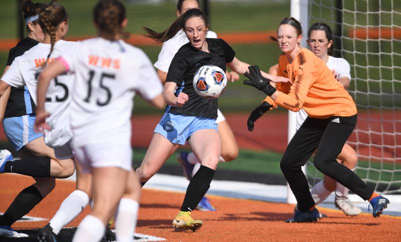 John Starks/jstarks@dailyherald.com
St. Charles North’s Rian Spaulding screens Wheaton Warrenville South goalkeeper Caroline Spayth as teammate Megan McGuire, obscured at left, charges in to shoot and score in the St. Charles East girls soccer sectional semifinal game on Tuesday, May 24, 2022.
