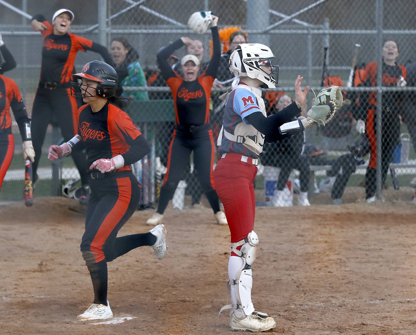 Crystal Lake Central's Ella Arana touches home plate behind Marian Central' catcher Bailey Keller in the eight inning to score the game winning run during a nonconference softball game against Marian Central on Thursday, April 3, 2025, at bates Park in Woodstock.