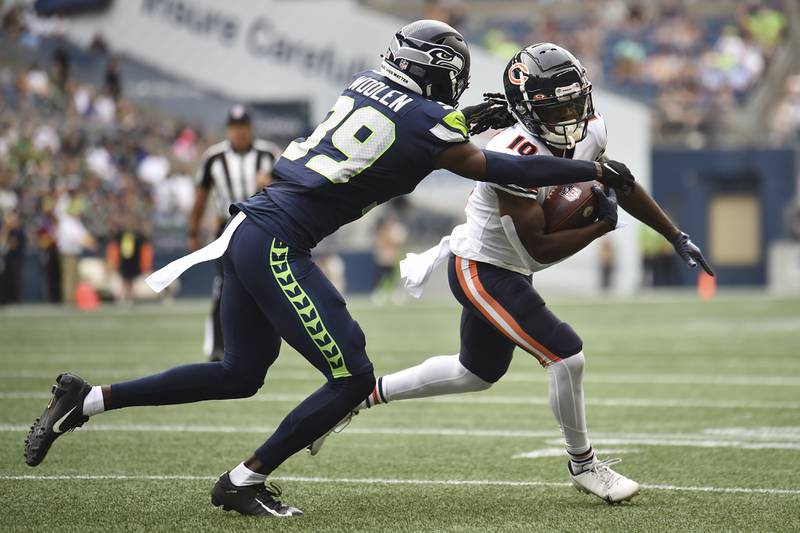 Chicago Bears wide receiver Nsimba Webster runs with the ball as Seattle Seahawks cornerback Tariq Woolen moves in for the tackle during the first half, Thursday, Aug. 18, 2022, in Seattle.