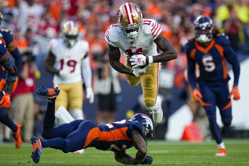 San Francisco 49ers wide receiver Brandon Aiyuk (11) is tackled by Denver Broncos safety Kareem Jackson (22) during an NFL football game Sunday, Sept. 25, 2022, in Denver. (AP Photo/Jack Dempsey)