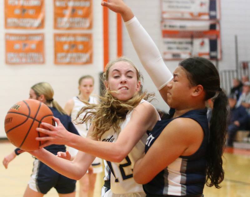 Marquette's Lilly Craig works to get inside the lane as Fieldcrest's Aliah Celis defends during the Integrated Seed Lady falcon Basketball Classic tournament on Monday, Nov. 13, 2023 at Flanagan High School.