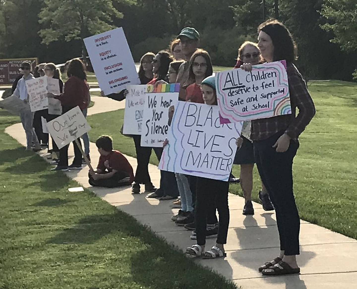 People picket before a Batavia school board meeting Tuesday.