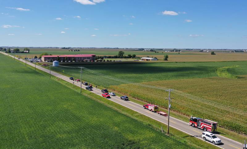 La Salle County Sheriff and other authorities gather along North 33rd Road next to a cornfield near Wallace Grade School on Wednesday, Aug. 30, 2023 north of Ottawa. Wallace Fire Department, Illinois State Police and Ottawa Police Department were called to the school shortly after a student who ran ran out of the school and into a cornfield.
