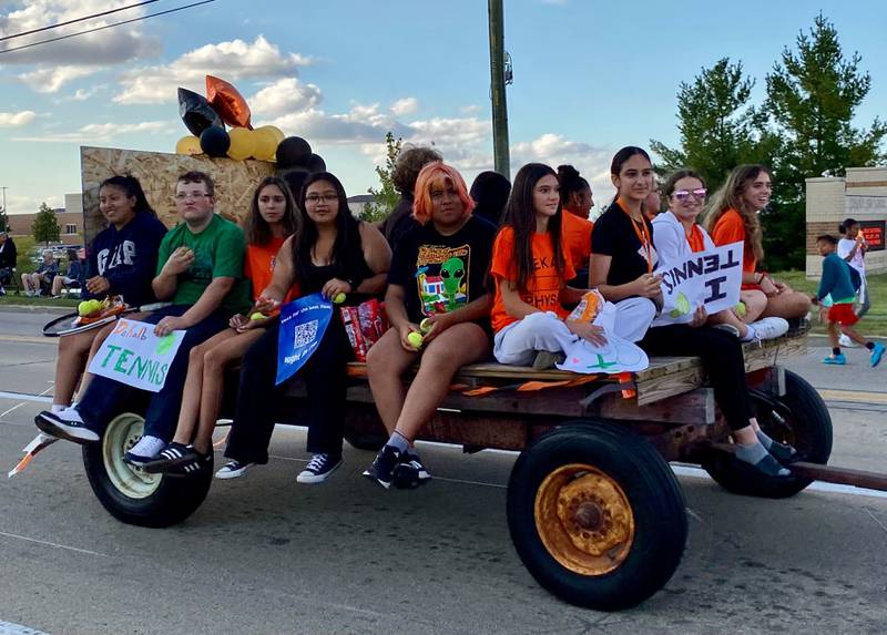 Members of the DeKalb Barbs girls tennis team smile as they ride the float together for the annual DeKalb High School Homecoming Parade on Wednesday, Sept. 24, 2025, along West Dresser Road.