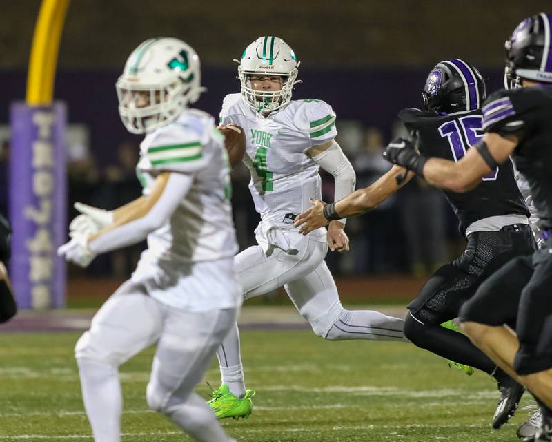 York's Sean Winton (4) rolls to the right looking for an open receiver during football game between York at Downers Grove North.  Sept 29, 2023.