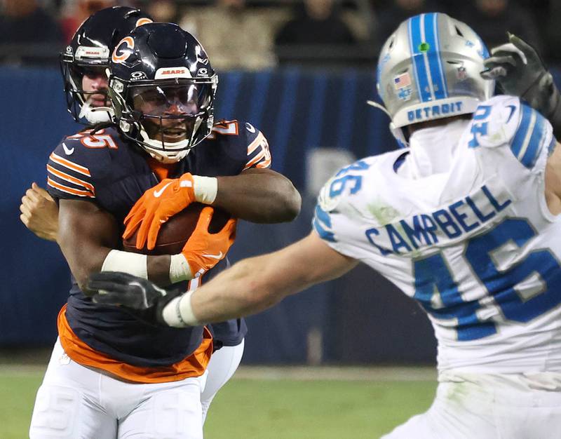 Chicago Bears running back Kyle Monangai looks to get by Detroit Lions linebacker Jack Campbell during their game Sunday, Jan. 4, 2026, at Soldier Field in Chicago.