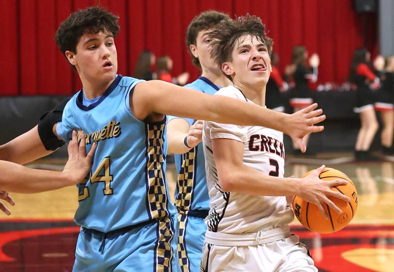 Indian Creek's Jason Brewer goes to the basket against Marquette’s Matt Graham Monday, Dec. 9, 2025, during their game at Indian Creek High School in Shabbona.