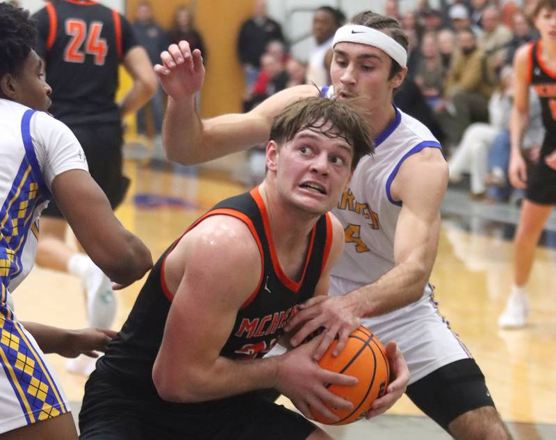 Warren’s Jack Wolf, back, guards McHenry’s Conner McLean in IHSA Class 4A Regional Title Game boys basketball action on Friday, Feb. 28, 2025 at McHenry High School in McHenry.