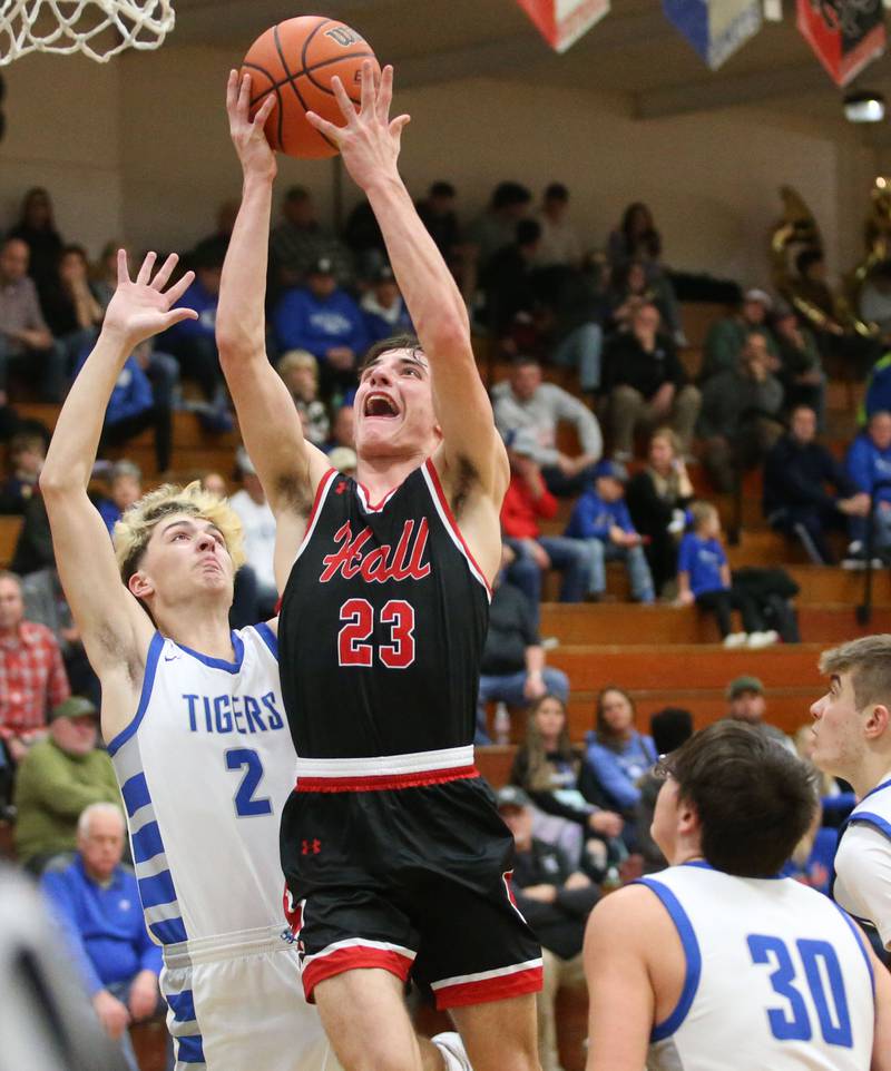 Hall's Braden Curran drives to the hoop to score over Princeton's Landon Roark and Sean Maynard on Friday, Jan. 26, 2024 at Princeton High School.