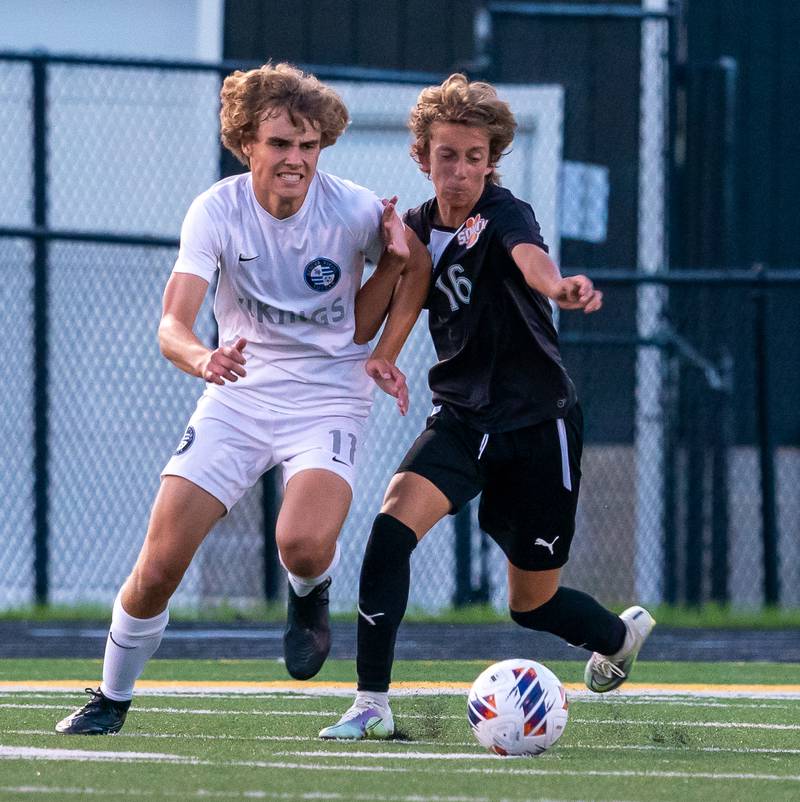 Geneva’s Jack Hatton (11) challenges Wheaton Warrenville South's Semin Razman (16) for the ball during a soccer match at Wheaton Warrenville South on Tuesday, Sep 13, 2022.